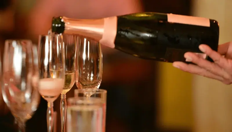 Champagne being poured into flutes glasses