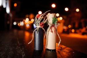 Bottles of wine wrapped as a gift with some Christmas decorations