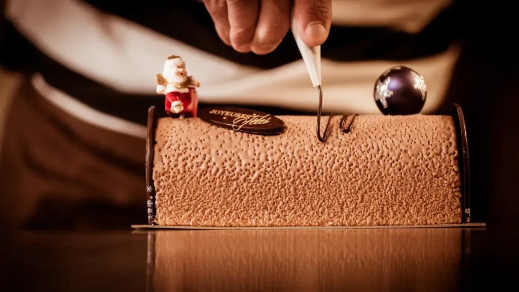 A Bûche de Noël being made by a pastry chef