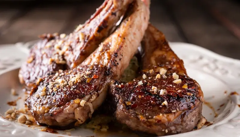 Three lamb chops in a plate