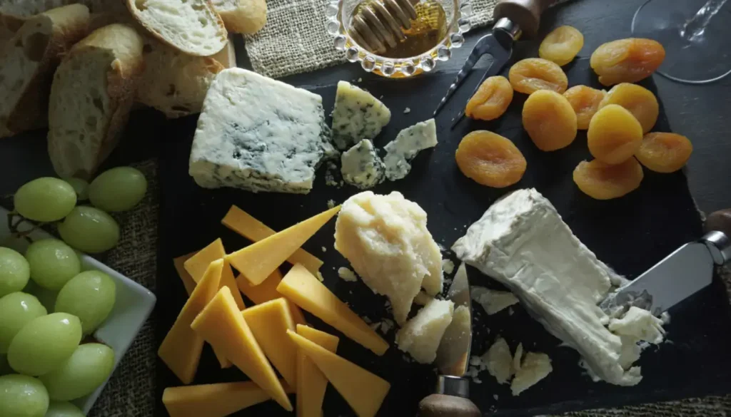 A Christmas cheese board with Stilton, grapes and a glass of Port
