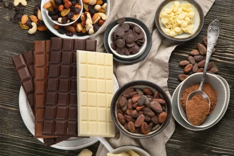 White, milk and dark chocolate tablets along with some nuts, chocolate-coated almonds and other types of chocolates