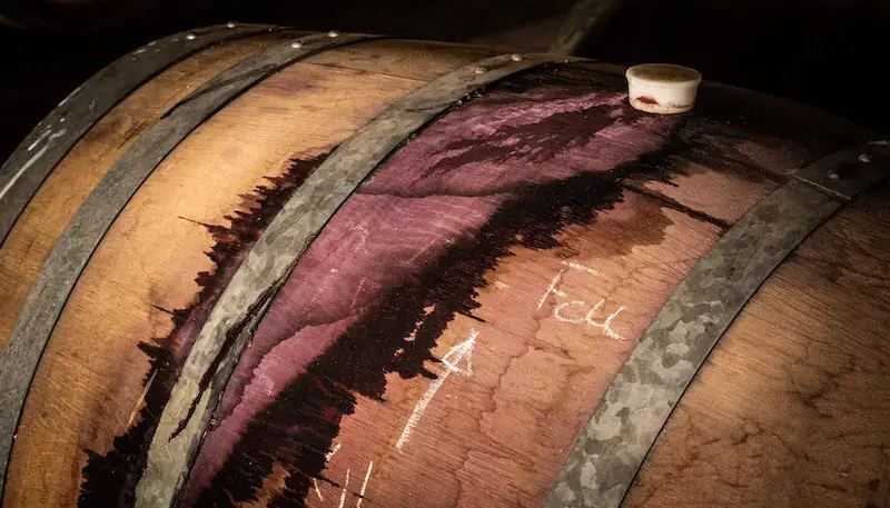 Wine barrels with a stain of red wine on the side
