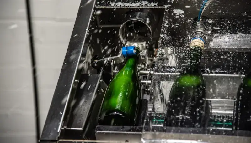 Disgorgement of sparkling wine bottles