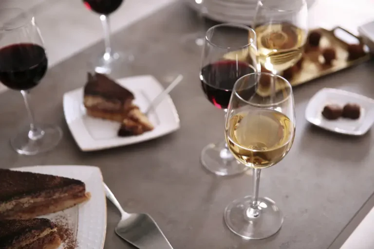 Glasses of wine served with slices of tiramisu and chocolate truffles