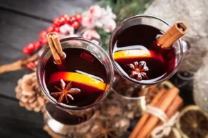 Two glasses of mulled wine with orange slices and cinnamon sticks