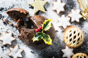 Christmas pudding with mince pies and Christmas biscuits on a table