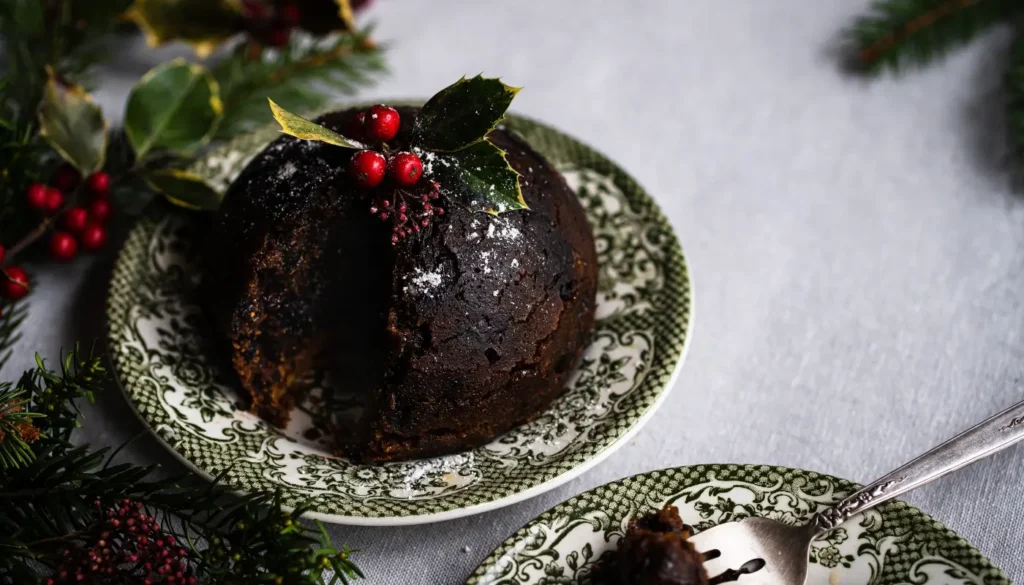 Christmas pudding on a table with some Christmas decorations