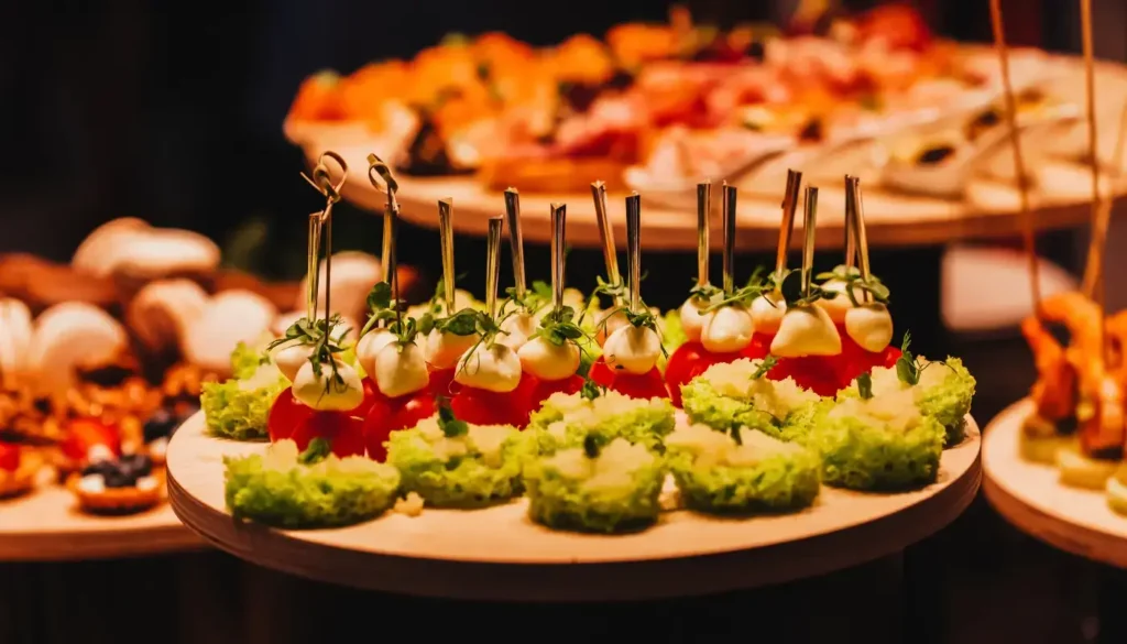 A platter of canapés with avocado on small toast and smoked salmon blinis